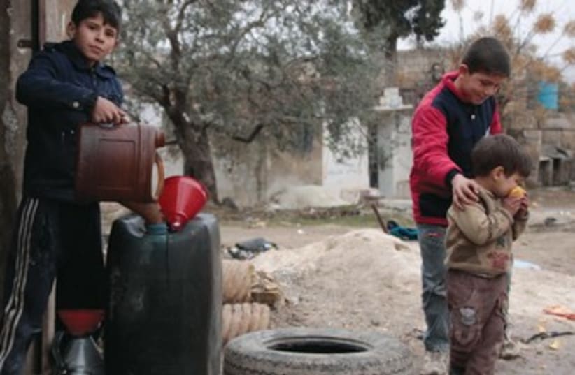 A child vendor sells fuel in Idlib. (photo credit: REUTERS)