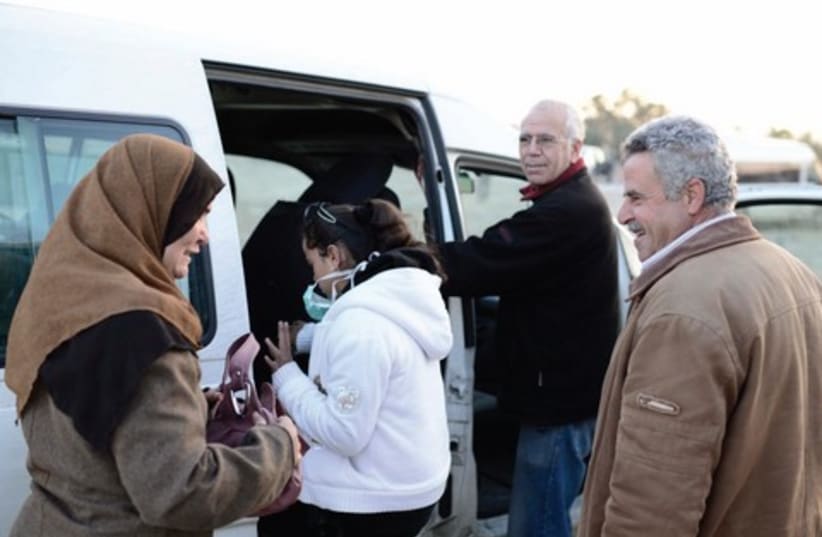 Yuval Roth (second on right) with Mohammed Darajmeh and his daughter Amani at the Eyal checkpoint getting into Roth‘s van (photo credit: TOMER NEUBERG/FLASH 90)