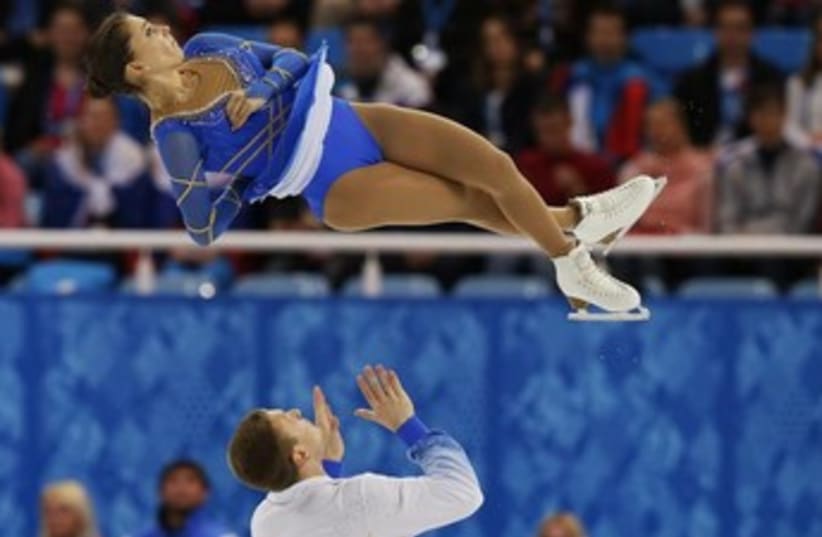 Andrea Davidovich (top) flies through the air after being tossed by partner Evgeni Krasnopolski. (photo credit: REUTERS)
