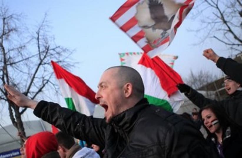 Hungarian far-rightists shout slogans outside a soccer match. (photo credit: REUTERS)