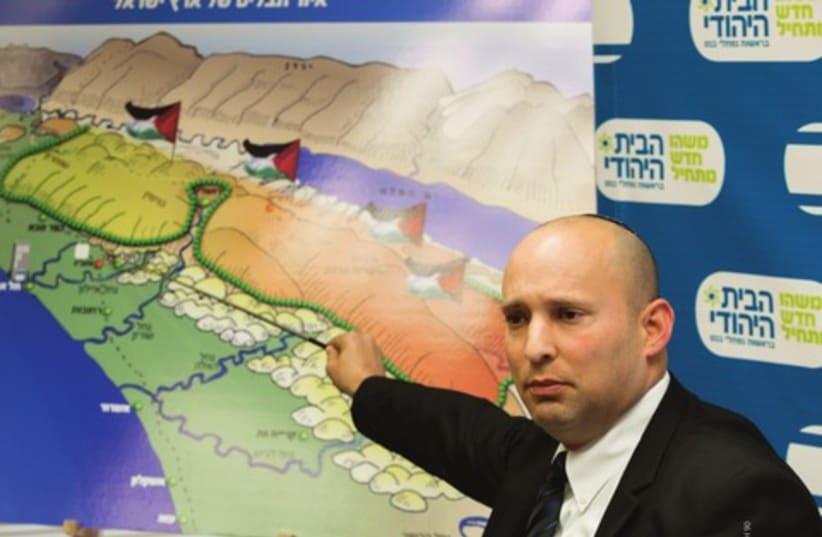 Bayit Yehudi party leader Naftali Bennett points to a map of the Palestinian state looming over the State of Israel (photo credit: FLASH 90)