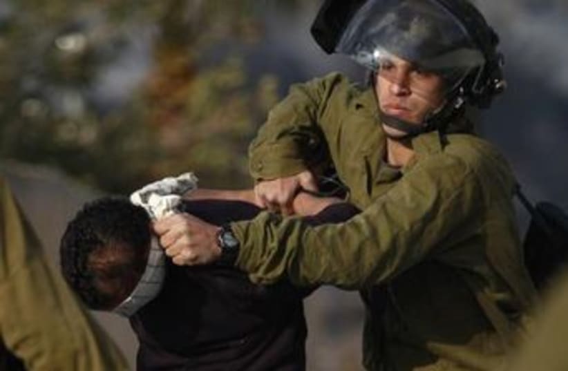 IDF soldiers arrest Palestinian suspect in West Bank (photo credit: REUTERS)