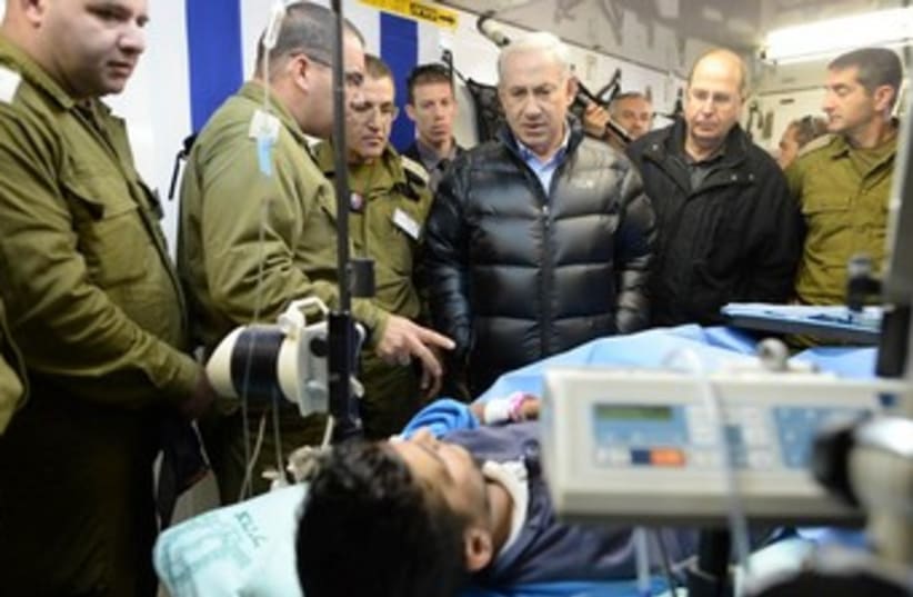 Netanyahu looks at Syrian patient IDF field hospital (photo credit: KOBI GIDEON/GPO)