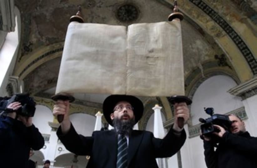 Rabbi Baruch Oberlander with Torah, February 18, 2014. (photo credit: REUTERS)