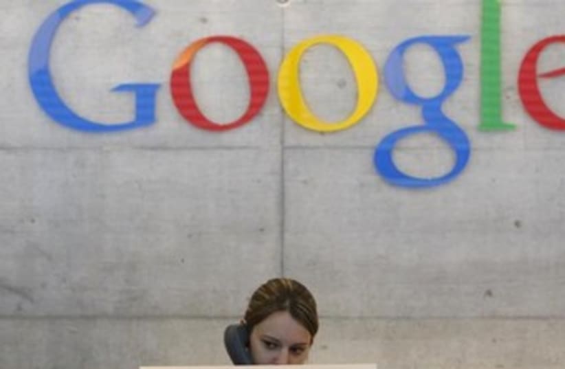 A Google employee answers the phone at the office switchboard in Zurich. (photo credit: REUTERS)