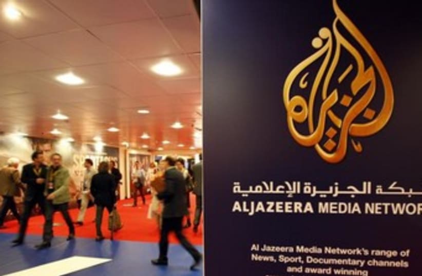 A sign with the logo of Al Jazeera Media Network (photo credit: REUTERS)