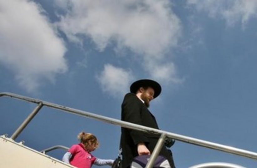 Haredi leaves plane [illustrative] (photo credit: REUTERS)