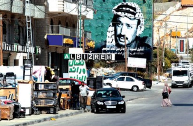 A poster of late Palestinian leader Yasser Arafat near the entrance to Ramallah. (photo credit: REUTERS)