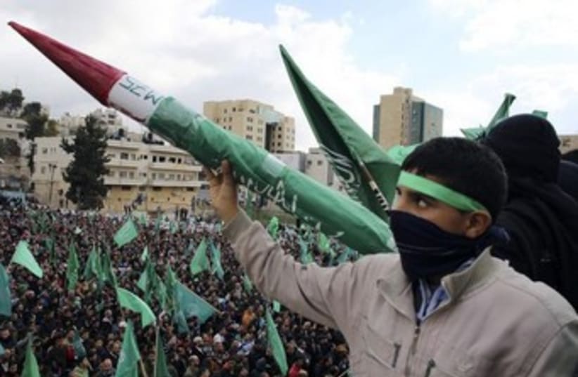 Palestinian youth hold Hamas-made rocket [File] (photo credit: REUTERS)