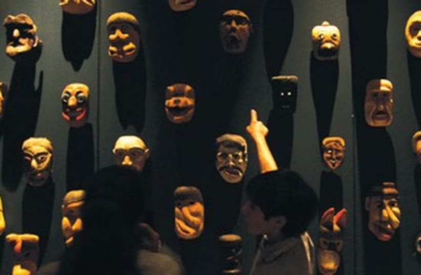 THE DEMENTED masks are shown minutes before they caused a terrible riot. (photo credit: REUTERS)