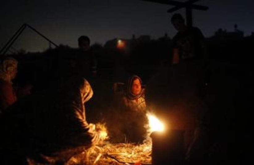 Palestinians in Gaza brave a power outage this past November. (photo credit: REUTERS)