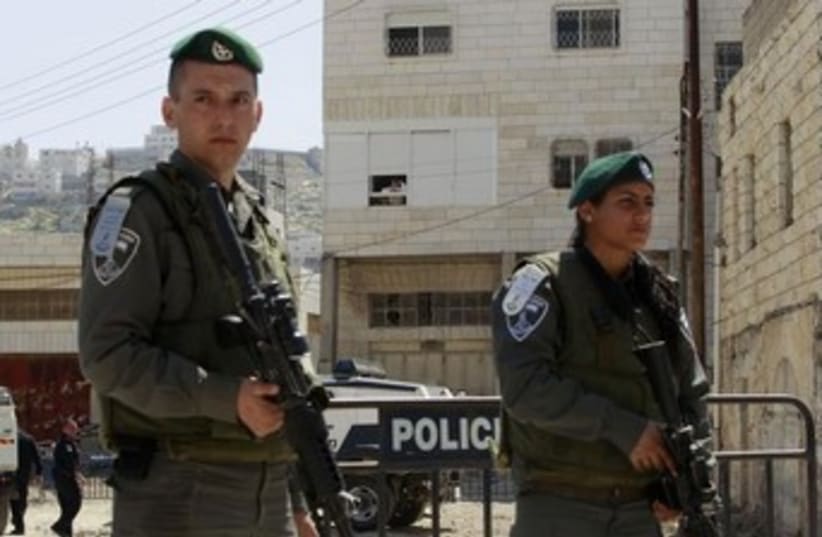 Border Police officers stand guard in Hebron. (photo credit: REUTERS)