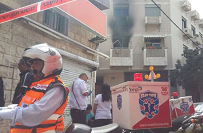 The scene outside a south Tel Aviv apartment hit by a suspected gas cannister explosion‏ (photo credit: UNITED HATZALAH‏)