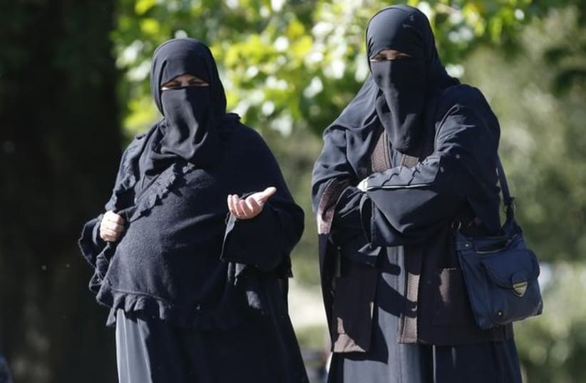 Women in full face veils walk in London's Regents Park (photo credit: REUTERS)