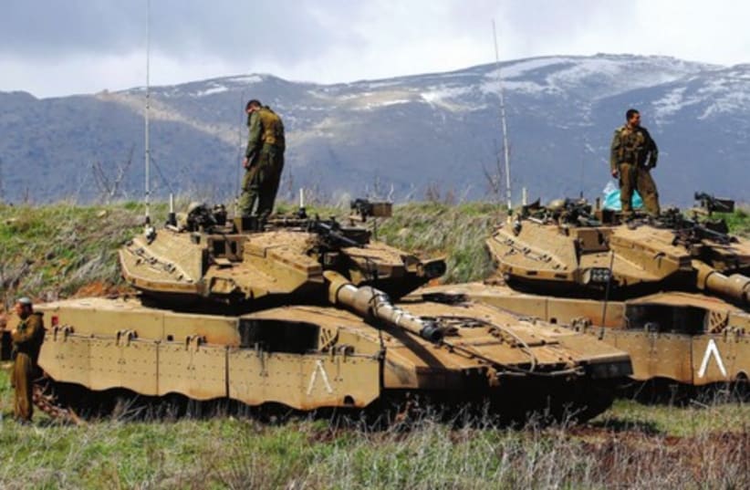 IDF tanks are deployed on Golan, March 19, after IAF hit Syria military sites in response to a roadside bomb (photo credit: REUTERS/Ronen Zvulun)