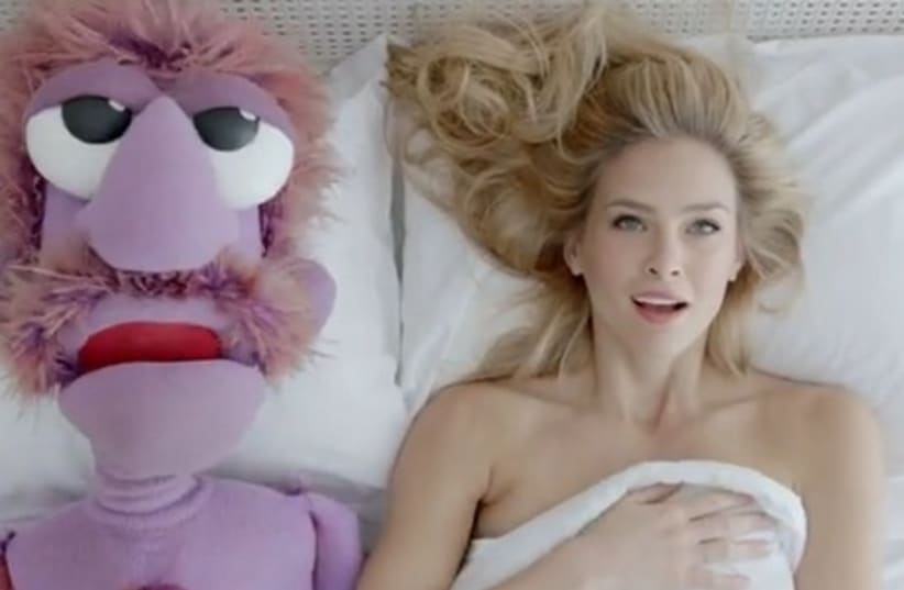 Bar Refaeli in bed with a muppet for the Hoodies commercial (photo credit: YOUTUBE SCREENSHOT)