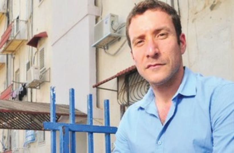 THE GOVERNMENT is only providing headlines, not solutions for the housing crisis, says Labor MK Itzik Shmuli, pictured outside the housing project where he lives in Lod. (photo credit: Courtesy)