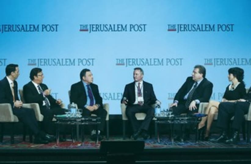 ‘JERUSALEM POST’ editor-in-chief Steve Linde (center) leads the socioeconomic panel discussion at JPost Conference  (photo credit: MARC ISRAEL SELLEM/THE JERUSALEM POST)