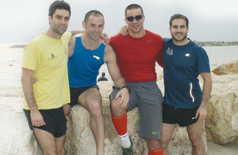 RUNNERS RAISING money for Beit Halohem, an organization helping disabled veterans of Israel, are (from L to R) Mark Goldman, Alex Dale, Oded Yogev and Ben Wahlhaus (photo credit: TOMER FEDER)