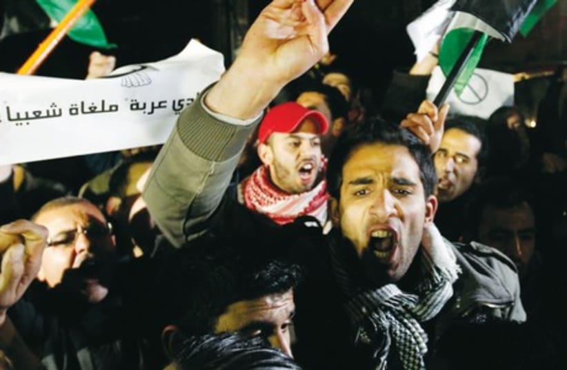 Demonstrator rage against Israel in protest in Amman, following shooting of Jordanian judge (photo credit: MUHAMMAD HAMED/REUTERS)
