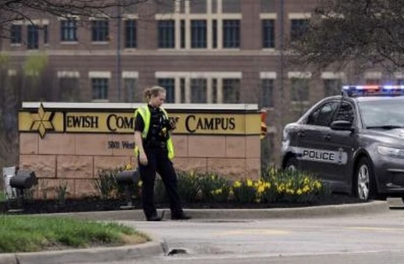 An Overland Park Kansas police officer at the scene of a shooting at the JCC of Greater Kansas City in Overland Park, Kansas April 13, 2014.  (photo credit: REUTERS)