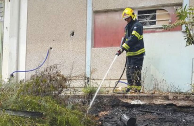Firefighter puts out fire in Kiryat Arba (photo credit: KIRYAT ARBA FIRE AND RESCUE SERVICES)