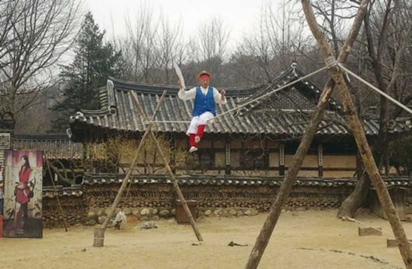 A tightrope walker performs at Minsok, a folk village dedicated to recreating traditional Korean day-to-day life. (photo credit: NOA AMOUYAL)