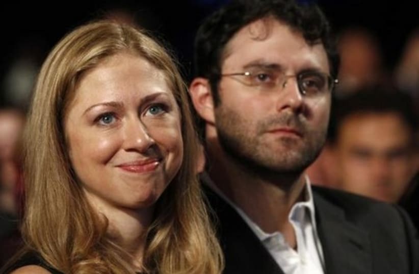 Chelsea Clinton and her husband, Marc Mezvinsky, attend a speech by US President Barack Obama at the Clinton Global Initiative in New York. (photo credit: REUTERS)