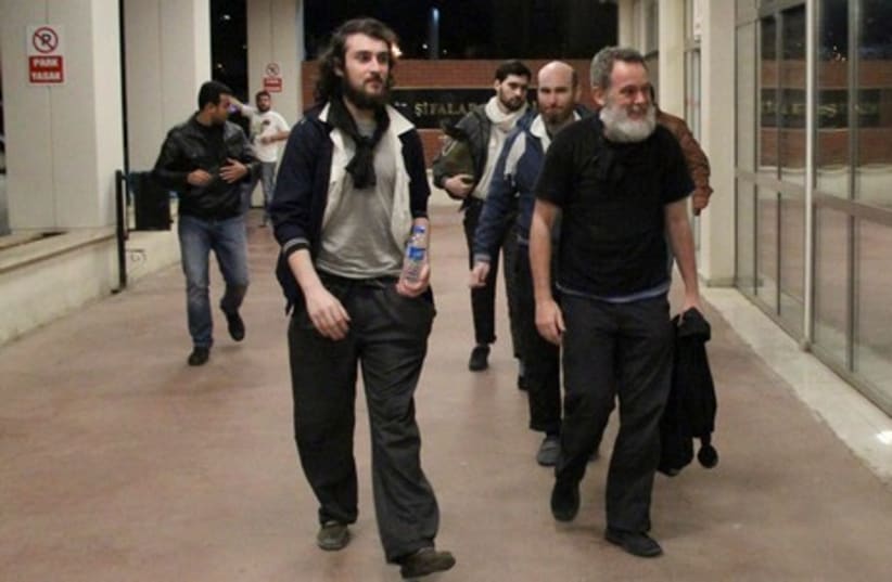 French journalists Edouard Elias (front L), Didier Francois (R), Nicolas Henin (2nd R, background) and Pierre Torres (3rd R, background) arrive at a hospital in Sanliurfa, Turkey, late April 18, 2014.  (photo credit: REUTERS)