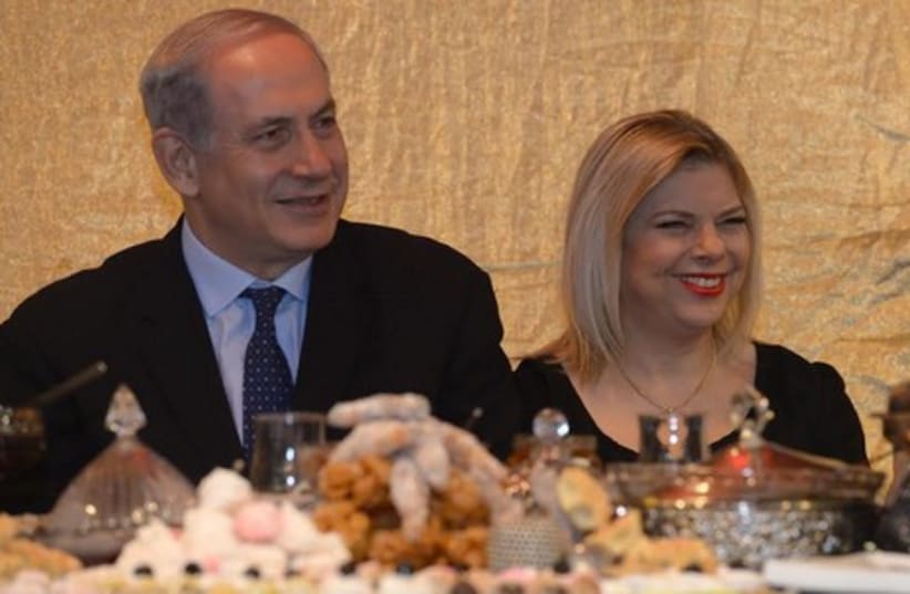  Prime Minister Binyamin Netanyahu and his wife Sara at a Mimouna celebration in Or Akiva. (photo credit: Mark Neiman/GPO)