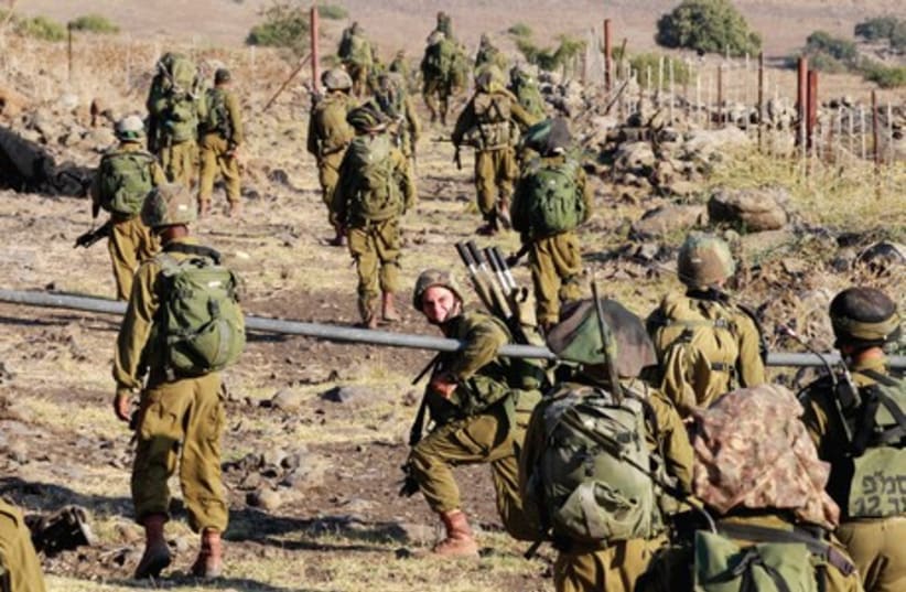 IDF soldiers participate in a drill on the Golan Heights. (photo credit: BAZ RATNER)