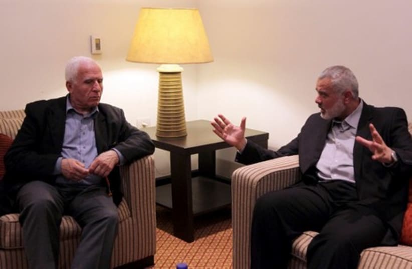 Hamas PM Haniyeh and PLO official Ahmed in Gaza unity talks (photo credit: REUTERS)