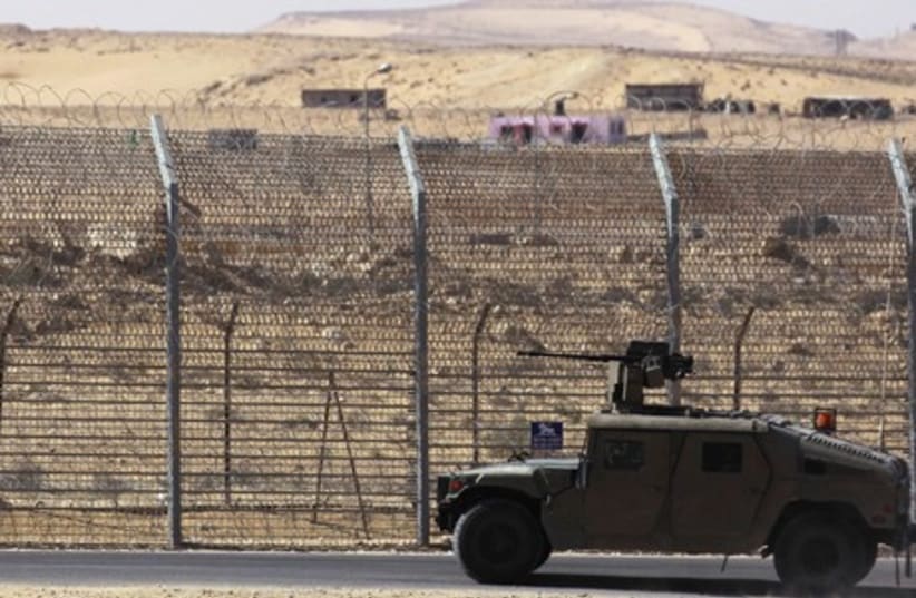 AN ARMORED IDF vehicle patrols a barrier along border with Egypt. (photo credit: REUTERS)