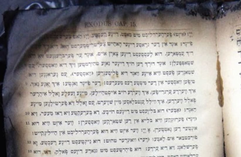 BURNT PRAYER books from a synagogue in Corfu, Greece that was firebombed in 2011 (photo credit: REUTERS)