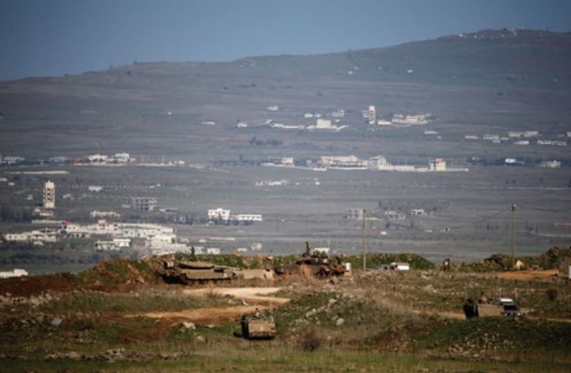 Soldiers patrol the Golan Heights. Israel has yet to demarcate a border with Syria and other borders remain politically disputed. (photo credit: REUTERS)