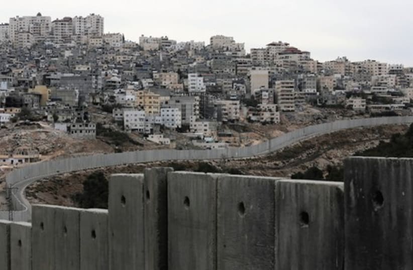 The security barrier runs along the Shuafat refugee camp. (photo credit: REUTERS)