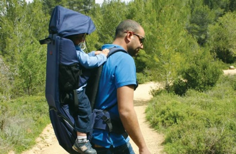 Etay Ziv, hiking with one of his children. (photo credit: Courtesy)