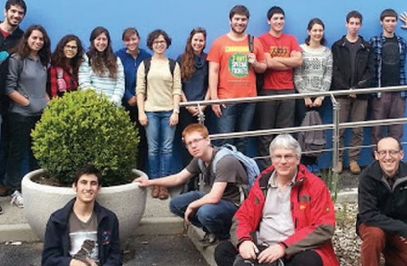 STUDENTS AND teachers from the Israel Arts and Sciences Academy pose for a group photo at the CERN Control Center in Geneva yesterday. (photo credit: COURTESY IASA)