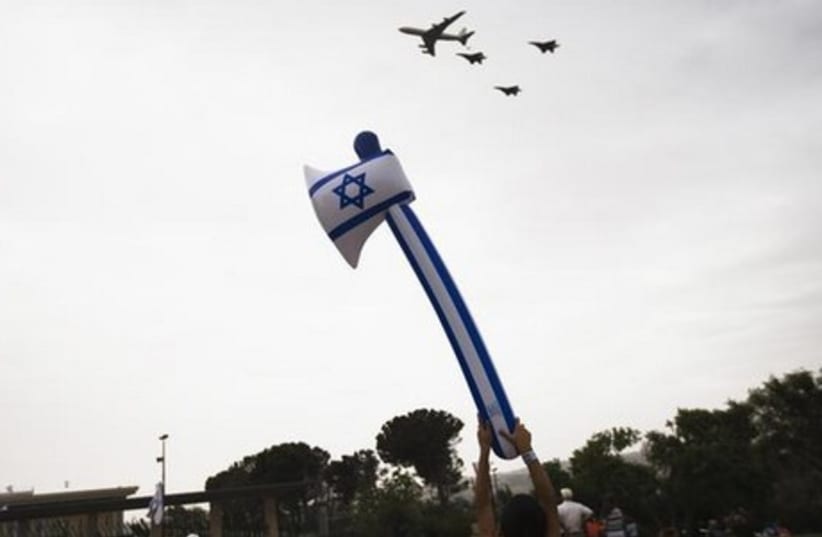 Israelis look on as a formation of IAF aircraft flies over the Knesset in Jerusalem on Tuesday. (photo credit: REUTERS)