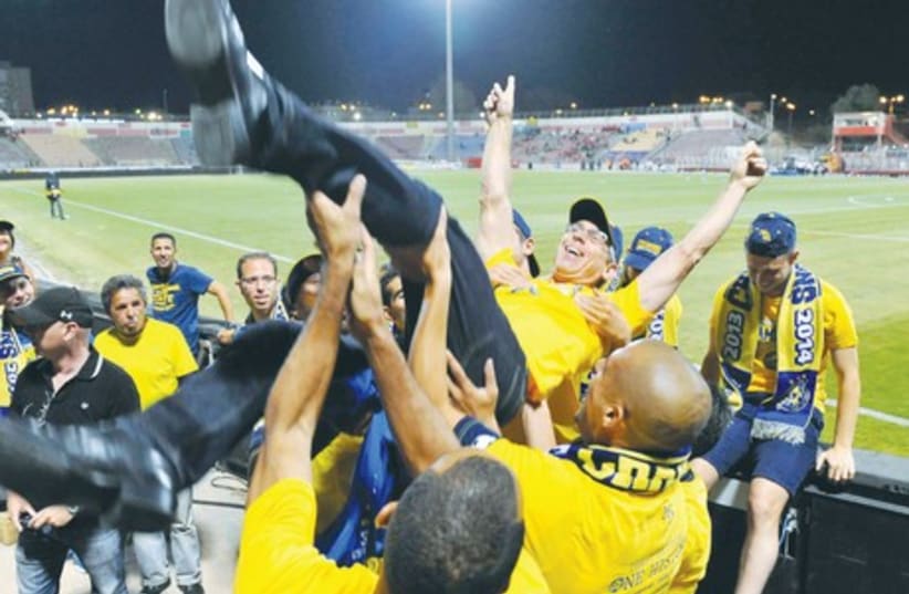Maccabi Tel Aviv owner Mitch Goldhar uncharacteristically allowed himself to celebrate after his team clinched the Premier League championship on Saturday night, but he already has his sights set on lifting many more titles. (photo credit: ASAF KLIGER)