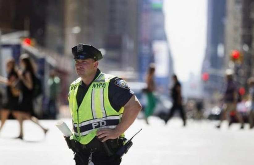 A New York Police Department officer stands in the street.  (photo credit: REUTERS)