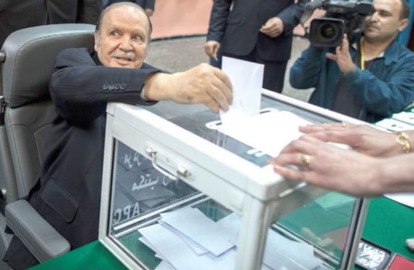 Algeria’s wheelchair-bound President Abdelaziz Bouteflika casts his ballot during the presidential election in Algiers, April 17 (photo credit: ZOHRA BENSEMRA/REUTERS)