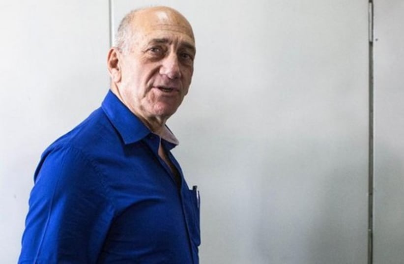 Former Israeli Prime Minister Ehud Olmert leaves Tel Aviv District Court May 13, 2014. (photo credit: REUTERS)
