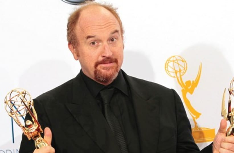 LOUIS CK holds Emmy awards for his show ‘Louie’ at the 64th Primetime Emmy Awards in Los Angeles in 2012. (photo credit: REUTERS)
