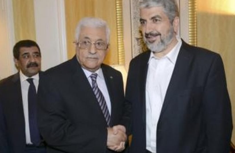 Palestinian President Mahmoud Abbas (L) shakes hands with Hamas chief Khaled Meshaal in Doha May 5, 2014.  (photo credit: REUTERS)