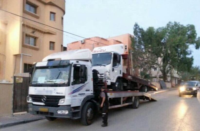 Towing one of the illegal trucks. (photo credit: ISRAEL POLICE)