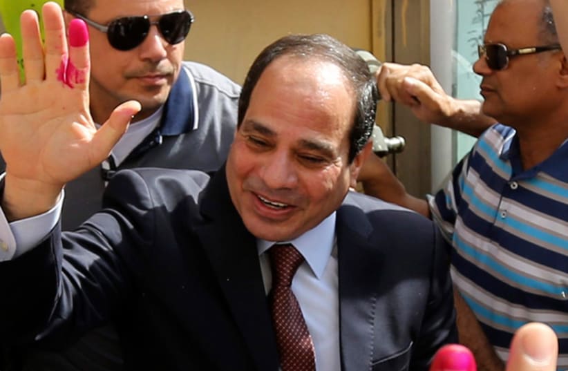 Abdel Fattah al-Sisi gestures after casting his ballot in Cairo, May 26, 2014 (photo credit: REUTERS)