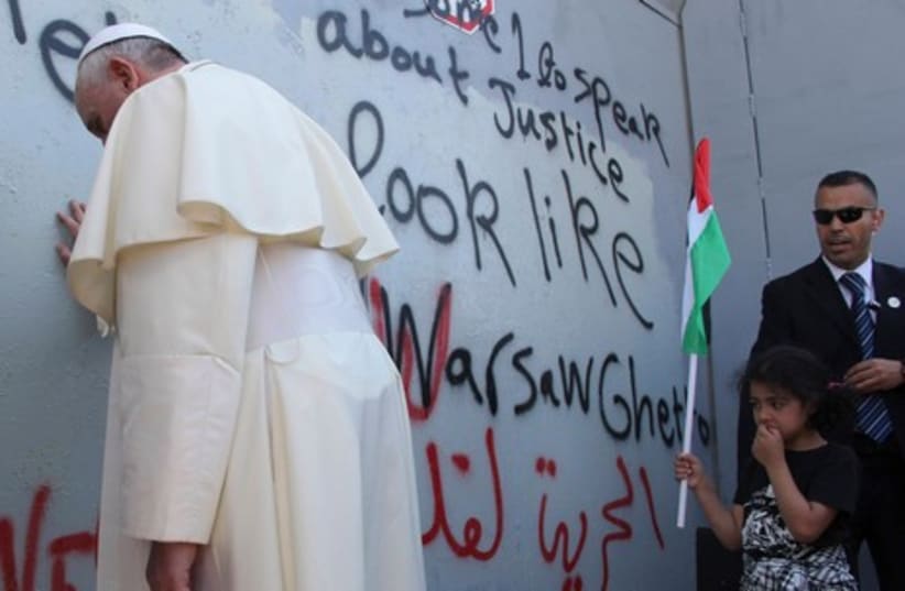 Pope Francis at the West Bank separation barrier (photo credit: REUTERS)