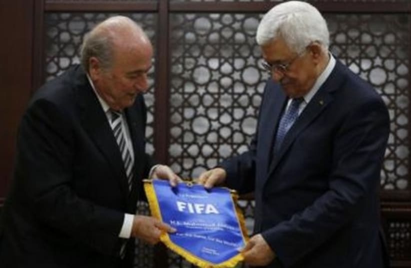 PA President Mahmoud Abbas (R) receives a gift from FIFA President Sepp Blatter in Ramallah May 26, 2014. (photo credit: REUTERS)