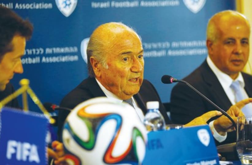 FIFA President Sepp Blatter (center) speaks during the news conference that was held May 27 in Jerusalem. (photo credit: REUTERS)